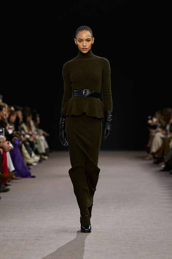 Max Mara Fall/Winter 2025 Fashion Show - Moss Green Look with Peplum Turtleneck, Belt, Gloves, Pencil Skirt and Mary Janes.